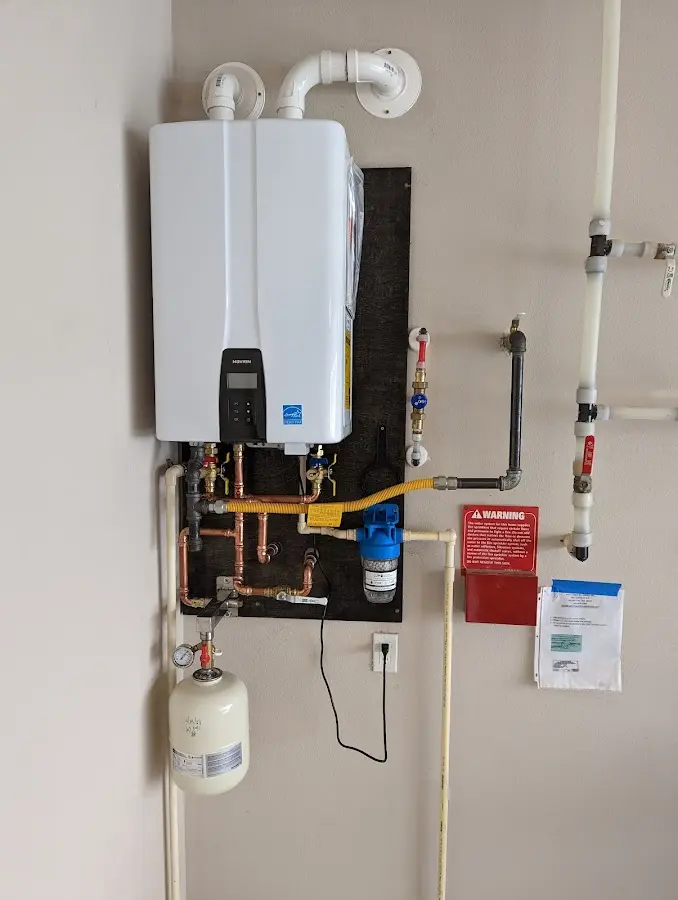 Professional plumber installing copper piping in a Eden Prairie home